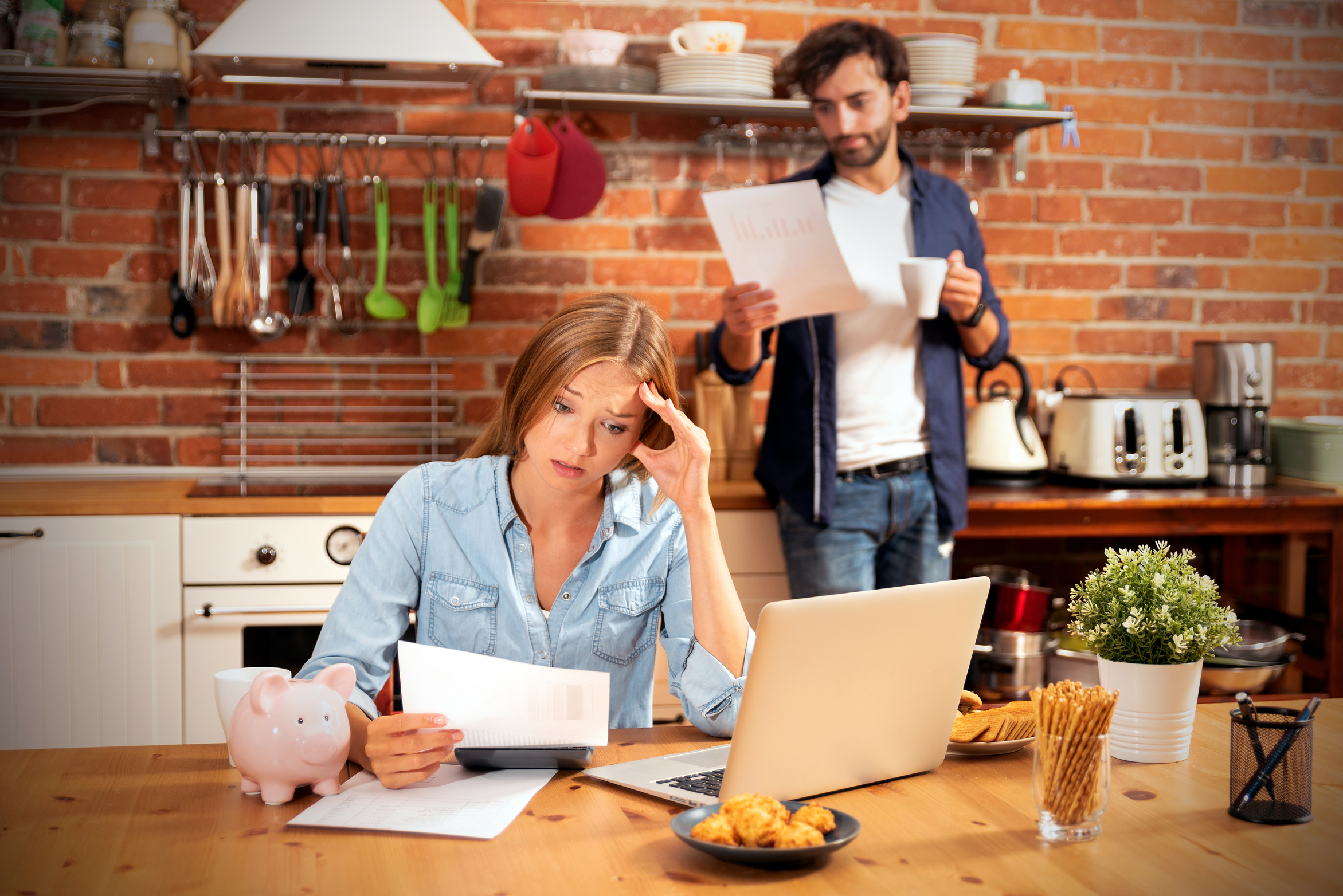 Stressed Couple Looking at their Bills in the Kitchen